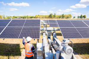 Wireless Solar Tracker Systems - Man Working on Solar Panels